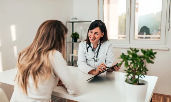 Two woman looking a chart. One is a doctor and the other is a patient